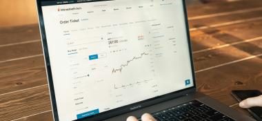Person at a laptop views a stock index chart